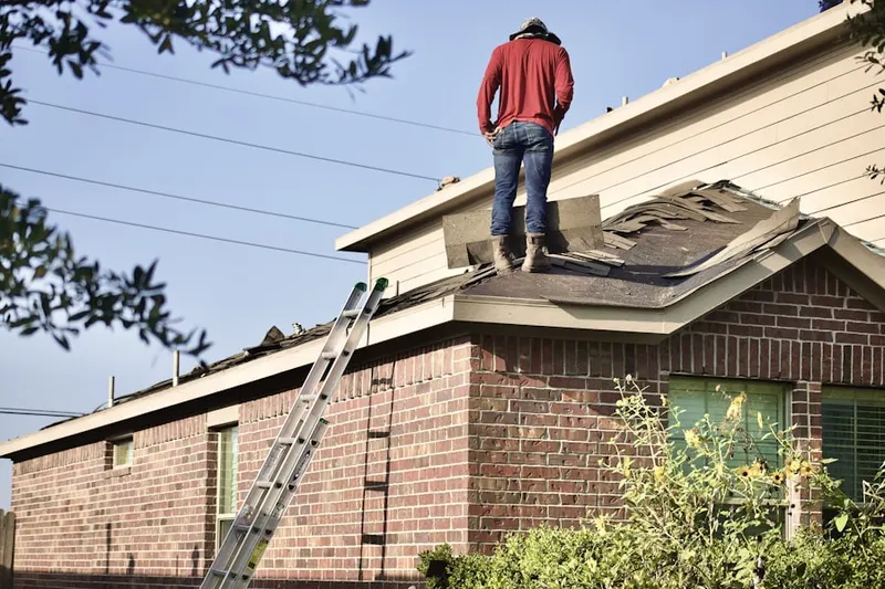 Professional roofer working on a residential roof in North University
